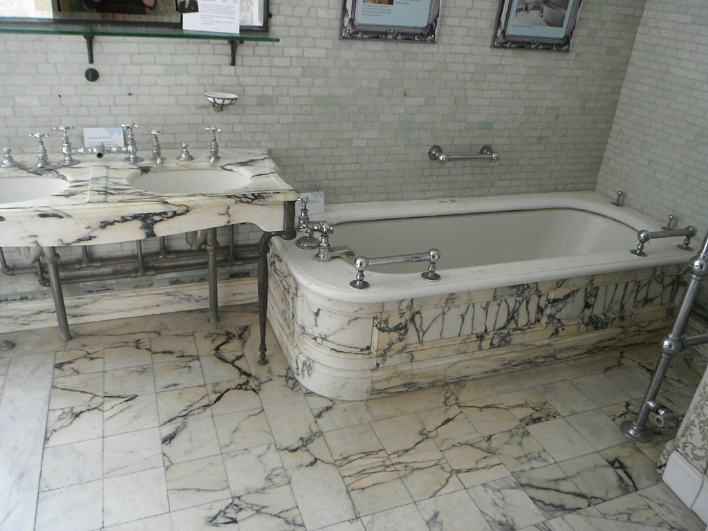 Marble bathroom with built-in tub and twin basins
