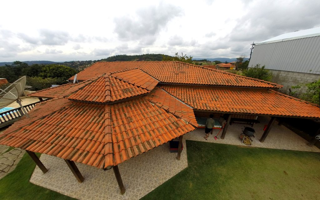 Warm terracotta tiled roofs over an open timber pavilion
